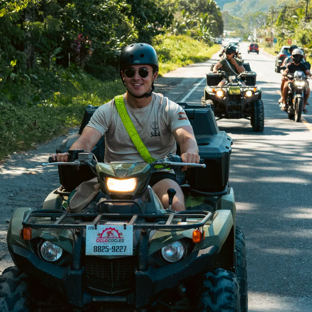 People riding ATVs on a road